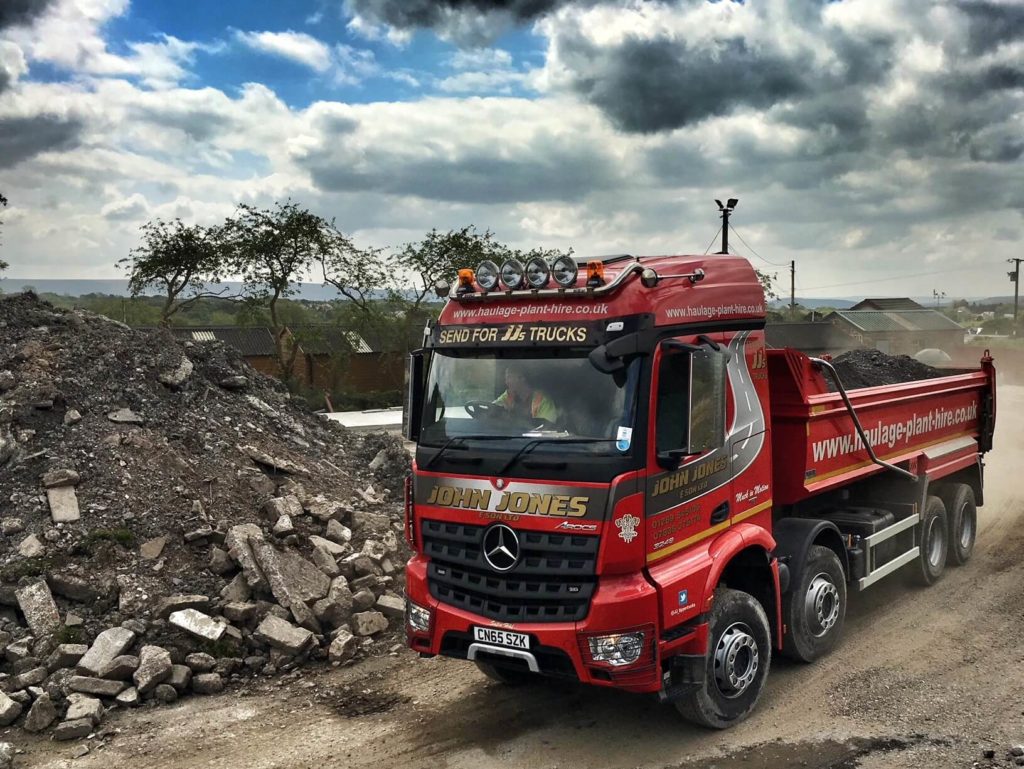 Tipper next to pile of rubble